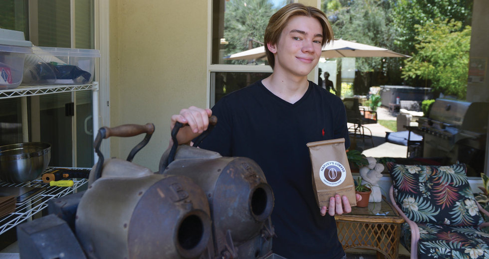 Harvey Uyeyama, the teenage founder of Harvey’s Coffee, shows off his roaster in his Davis backyard. (Photo by Bea Ahbeck)