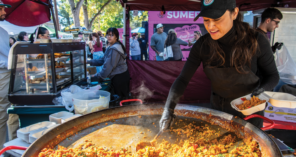 Maria Perez dishes up paella at Sacramento's Midtown Farmers Market. (Photos by Debbie Cunningham)