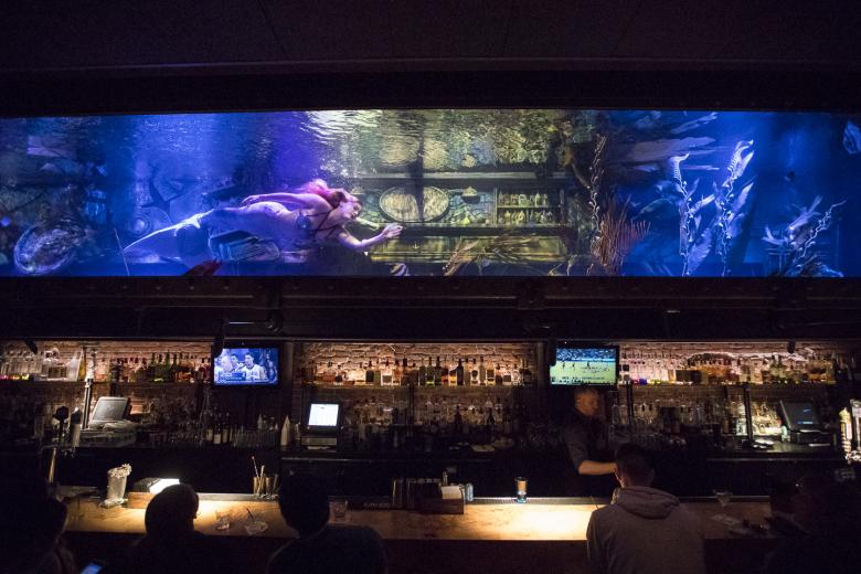 Rachel Smith swims through the 7,500-gallon aquarium at the Dive Bar in downtown Sacramento. Smith, 27, grew up in Hawaii as a “water baby,” as she describes herself, with parents who performed Polynesian dance. As a teenager who loved to perform, she asked her mother (a seamstress) to make a mermaid tail in which she could swim.