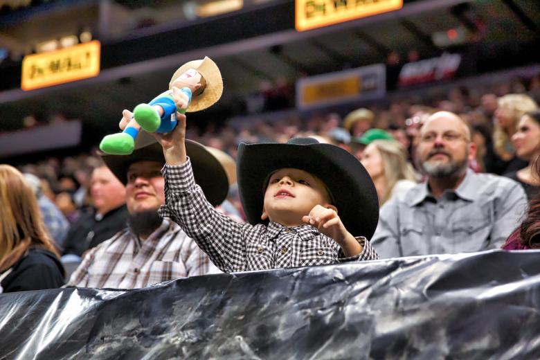 Longtime PBR fan Carlos Olayo and son Lucas, 4, of Yuba City, during their second trip together to a PBR event.