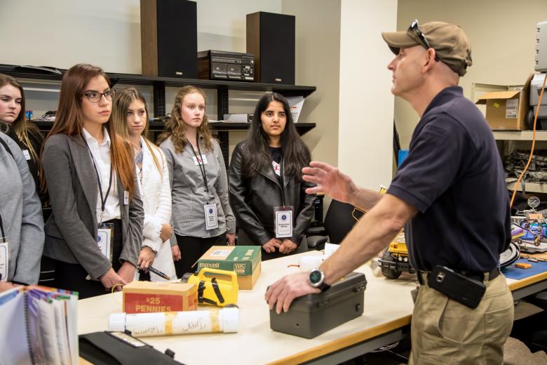 Members of the FBI Teen Academy listen to a presentation by special agent bomb techs.