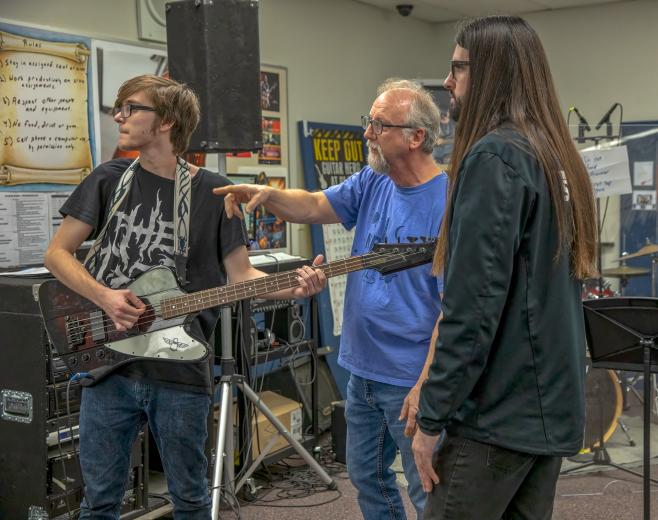 “The enthusiasm and camaraderie that students develop after they have been involved in Blues in the Schools last much longer than the six weeks that the students are in the program,” says Steve Boettner. Guitarist Clinton Jones takes instructions from Boettner and BITS instructor Matt Hevesh in March. (Photo by Steve Martarano)