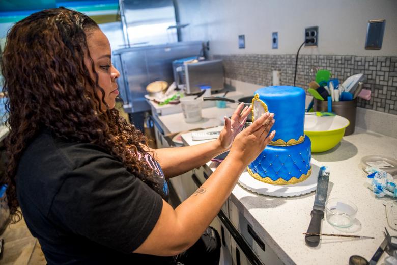 The Cake Depot makes inventive sculptures, having worked on edible projects from Air Jordan rice krispie treat replicas to a cake bustier for a bachelorette party. Above, Stevenson works on a themed cake for a baby shower, which takes about eight hours to complete.