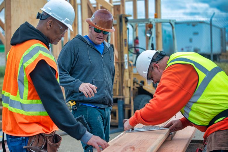 NCCT instructor Chris Pearson (middle) directs students working on garden boxes for a school affected by the Camp Fire. As an instructor who admits to making some bad life choices in the past, Pearson says he shares lessons he learned with his students. “I show them there is another way to live,” he says (Photo by Steve Martarano)