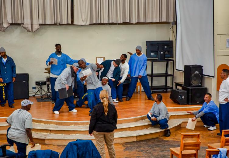 Lynn Baker-Nauman directs inmates as they rehearse “The Tempest” at Folsom State Prison. “There’s a lot of intense moments for them to learn how to trust someone who, out in the prison yard, might not be able to talk with them,” Baker-Nauman says. (Photo by Steve Martarano)