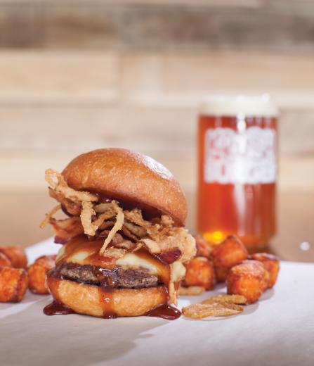 Krush Burger: The Cowbell burger with certified angus beef, smoked gouda, crispy onions, applewood smoked bacon, barbecue sauce and a side of crispy sweet potato tater tots. Paired with a Deschutes Mirror Pond Ale. Krush Burger: The Cowbell burger with certified angus beef, smoked gouda, crispy onions, applewood smoked bacon, barbecue sauce and a side of crispy sweet potato tater tots. Paired with a Deschutes Mirror Pond Ale.
