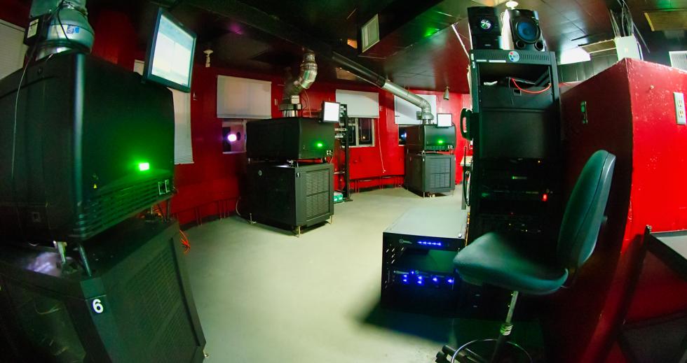 Inside the West Wind projection room as three of the six all-digital projectors play movies. Unless there’s an emergency, no humans are present inside the projection room while movies are running.