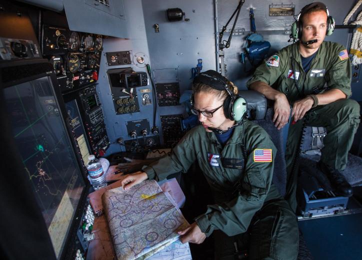 Avionics Electrical Technicians Amanda Hansen and Dan Boyd man the cockpit of a C-130 aircraft during a training mission departing from the Coast Guard air station at McClellan. Avionics Electrical Technicians Amanda Hansen and Dan Boyd man the cockpit of a C-130 aircraft during a training mission departing from the Coast Guard air station at McClellan.