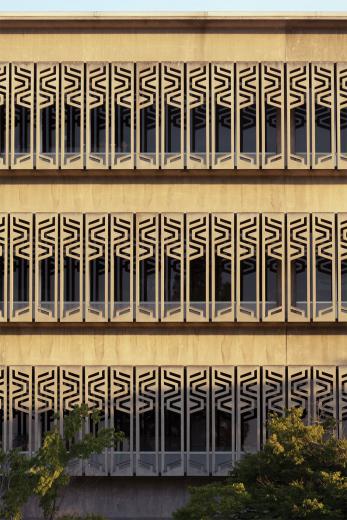 The concrete lattice frame acts as a sunscreen by providing the thermal mass to capture, store and release heat internally during the winter months. The orientation of each decorative façade carries a different shade device, creating various reflected patterns. The south side blocks the sun from above, and the east/west side reduces as much solar gain as possible. The concrete lattice frame acts as a sunscreen by providing the thermal mass to capture, store and release heat internally during the winter months. The orientation of each decorative façade carries a different shade device, creating various reflected patterns. The south side blocks the sun from above, and the east/west side reduces as much solar gain as possible.