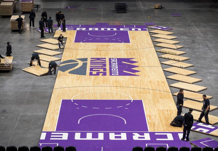 The floor consists of 233 wood panels, each eight feet long and four feet high weighing roughly 185 lbs each, according to Sacramento Kings Manager of Arena Operations Chris Spann. The team works in groups of five, starting from the centerline and then moving outward.