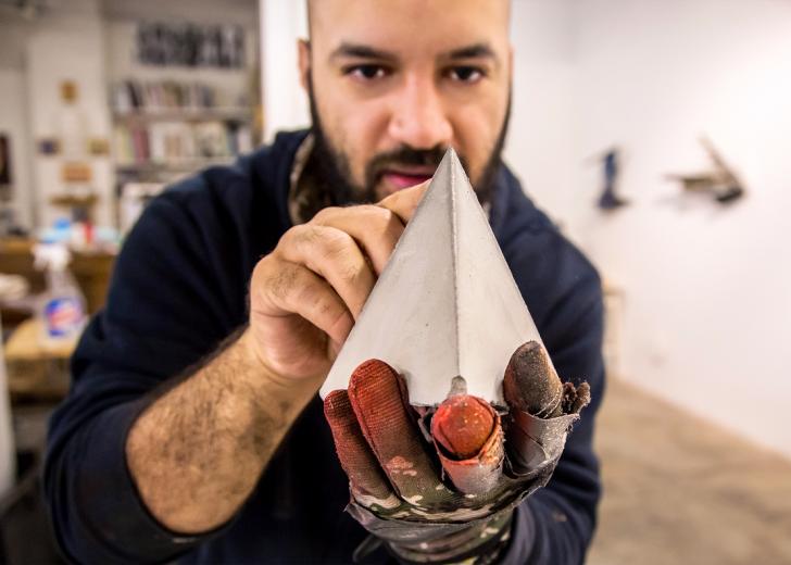 In his studio, Raphael Delgado inspects a concrete prism that will be part of his installation for the WAL lobby and stairwells In his studio, Raphael Delgado inspects a concrete prism that will be part of his installation for the WAL lobby and stairwells