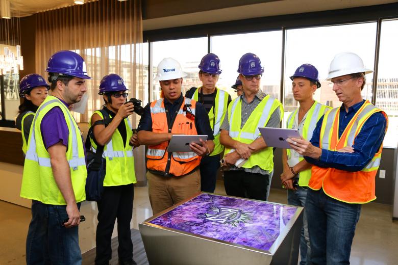 Tour leaders Adam Holguin of Turner Construction and Mark Posnick of the Weston Group/Williams+Paddon a consultant to the city, show a virtual rendering of the new arena to artists (in yellow vests, from left) Jiayi Young, Stephane Come, JD Beltran, Scott Minneman, Nelson Loskamp and Jess Riegel. Tour leaders Adam Holguin of Turner Construction and Mark Posnick of the Weston Group/Williams+Paddon a consultant to the city, show a virtual rendering of the new arena to artists (in yellow vests, from left) Jiayi Young, Stephane Come, JD Beltran, Scott Minneman, Nelson Loskamp and Jess Riegel.
