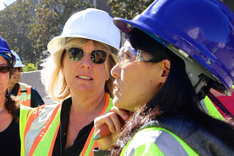 SMAC Executive Director Shelly Willis talks with artist Jiayi Young during a street tour around the perimeter of the downtown arena construction site.
SMAC Executive Director Shelly Willis talks with artist Jiayi Young during a street tour around the perimeter of the downtown arena construction site.