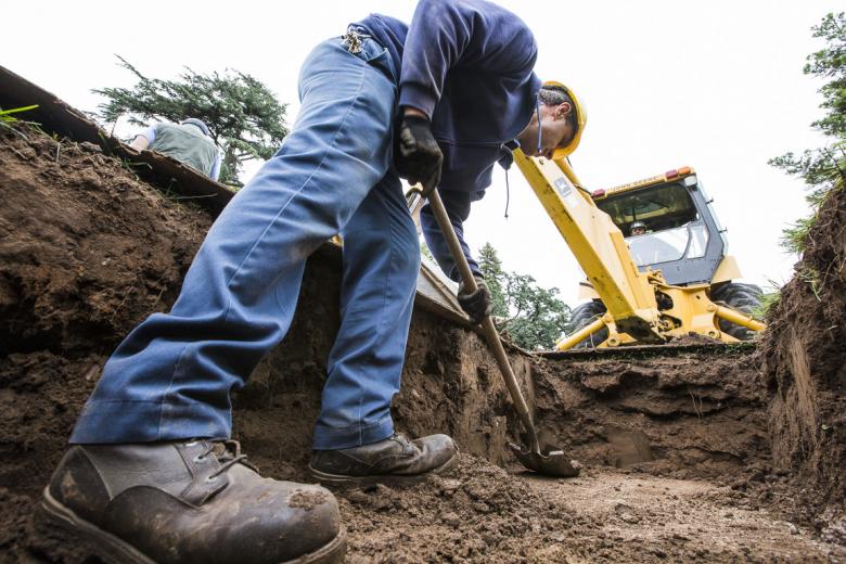 Nick Ustymchuk, a groundsman at Sacramento’s East Lawn Memorial Park, uncovers a concrete vault after foreman Mike Kalenyuk opens the burial site with a backhoe. Kalenyuk is related to Ustymchuk by marriage, and his brother, Igor Kalenyuk, is East Lawn's project manager. Nick Ustymchuk, a groundsman at Sacramento’s East Lawn Memorial Park, uncovers a concrete vault after foreman Mike Kalenyuk opens the burial site with a backhoe. Kalenyuk is related to Ustymchuk by marriage, and his brother, Igor Kalenyuk, is East Lawn's project manager.