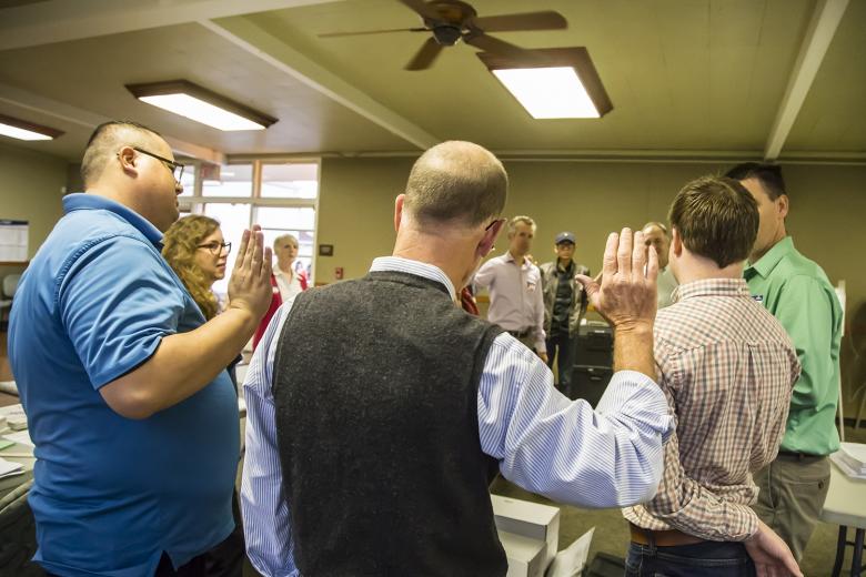 Before the doors open, the election inspectors administer an oath to the nine people who will work the polls. Poll workers receive $125 for their long day’s service.