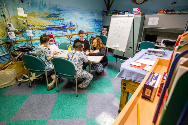 When their health permits, Castles prefers to gather her subjects in the hospital’s teen room, which doubles as her classroom from 10 a.m. to noon on weekdays. "The goal is really to get them in the classroom with me, but it’s hit or miss," says Castles. “A lot of times they aren’t well enough, and we just can’t get them in here.”
When their health permits, Castles prefers to gather her subjects in the hospital’s teen room, which doubles as her classroom from 10 a.m. to noon on weekdays. "The goal is really to get them in the classroom with me, but it’s hit or miss," says Castles. “A lot of times they aren’t well enough, and we just can’t get them in here.”