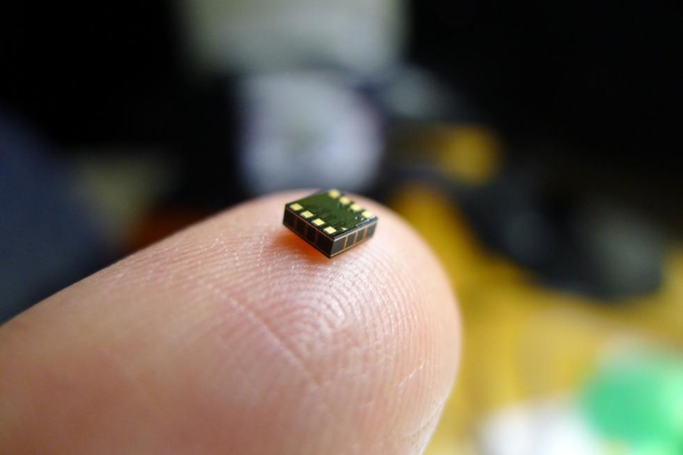UC Davis professor David Horsley balances one of his ultra-small, ultra-low power sensors on the pad of his finger. He and his team at CHIRP Microsystems in the Bay Area are working to build sensors that are increasingly smarter and smaller.