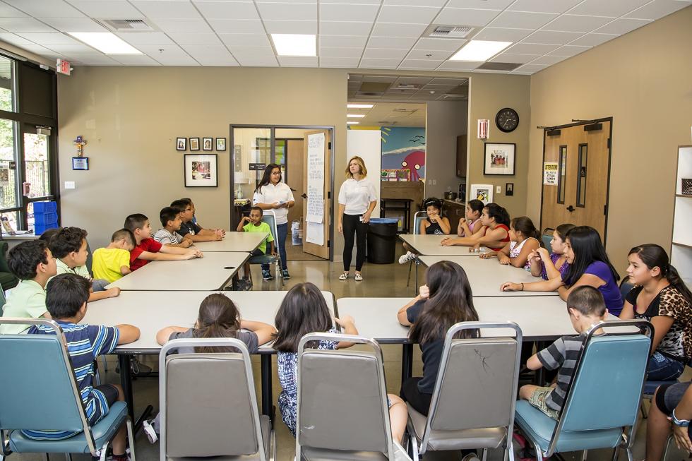 Interns Margarita Armijo (left) and Camryn Agnello encourage children to introduce themselves to other summer camp attendees.