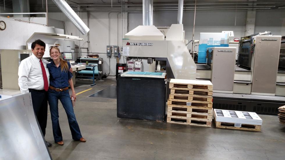 Commerce Owner Gil Caravantes with Comstock’s Editor in Chief Allison inside the Sacramento printing company.
