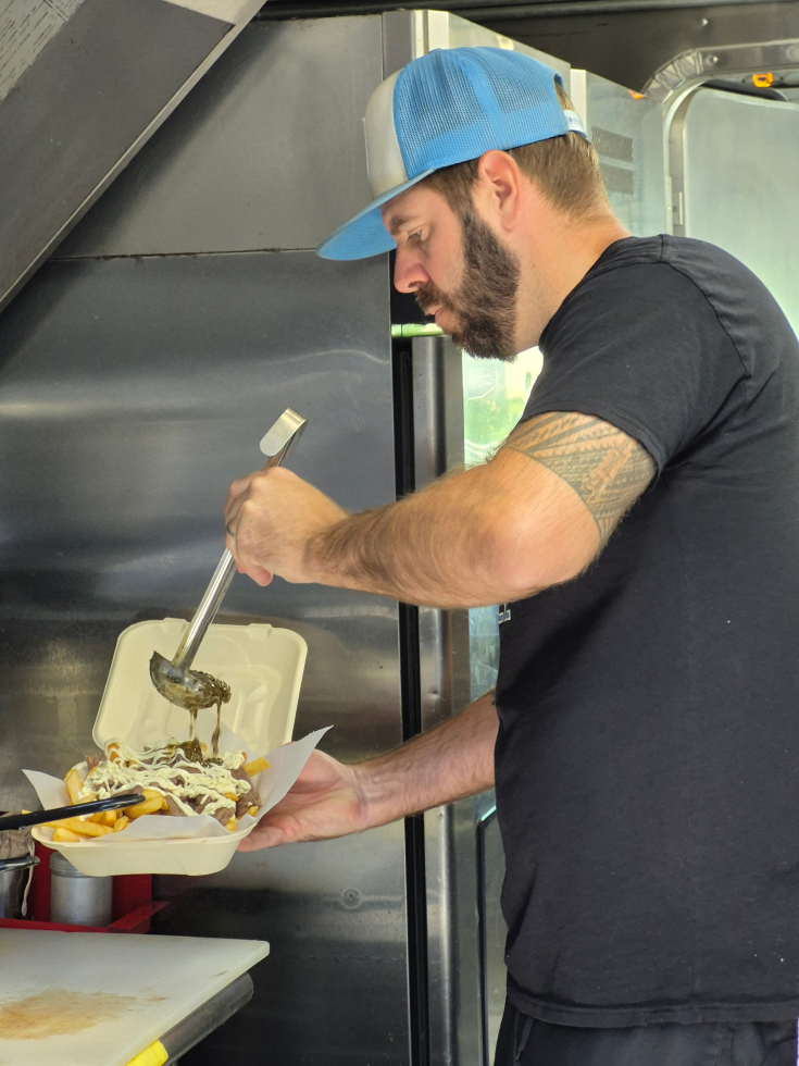 Shane Twilla prepares Buenos Aires Grill's signature "messy fries." (Photo by Sasha Abramsky)