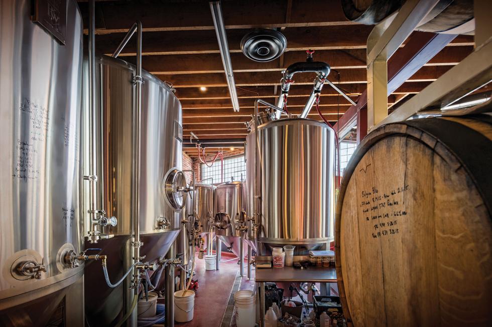 The gleaming copper-clad 7-barrel brewing system sits behind glass on the far wall inside Oak Park Brewing, where diners can watch brewers in action.