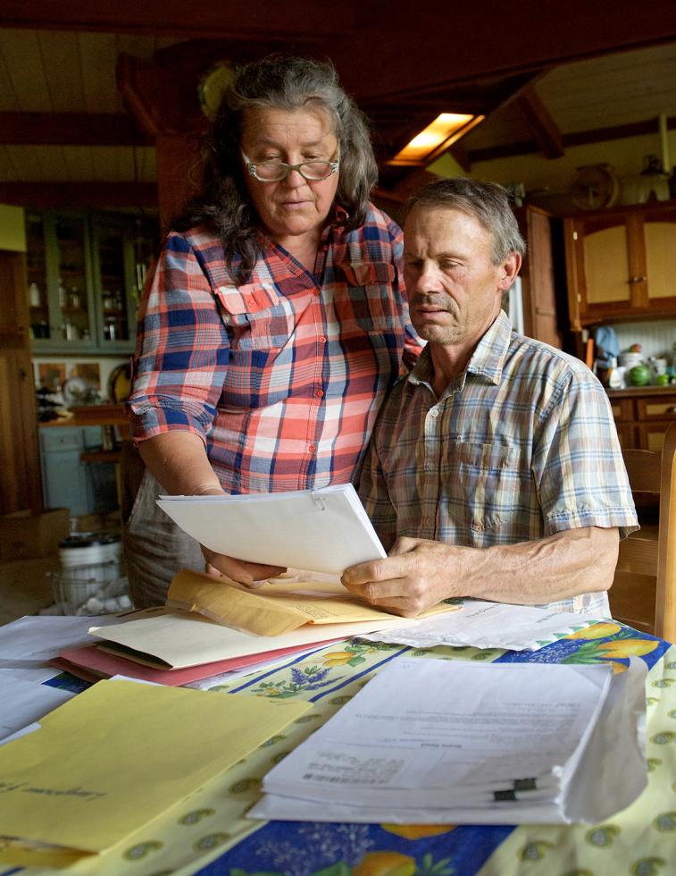 Annie and Jeff Main, of Good Humus Produce, examine paperwork for securing a conservation easement for their farmland