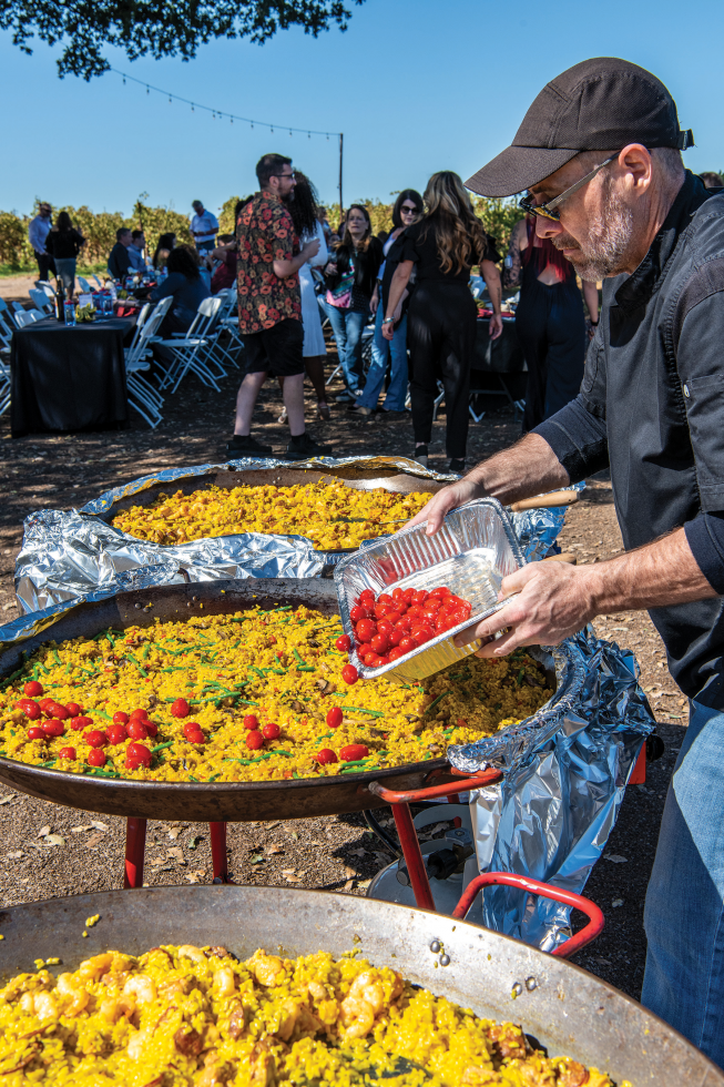 Paul Grant helps his wife, Addy Grant, prepare paella for an event at Bokisch Vineyards in Lodi.