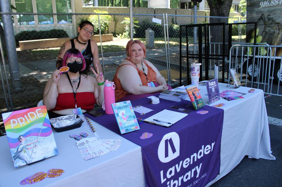 Volunteers for the Lavender Library table at the Sacramento Pride Festival, giving out information to people interested in visiting and supporting the library. Trujillo and Parsons estimated the library had 80 to 90 volunteers, the highest number in its history. (Photo by Jacob Peterson)