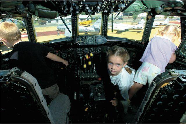 Sept. 2004: Rio Linda residents Conner and Kaylee Logan check the view from the cockpit of an Air Force EC-121 aircraft. The plane, which did coastal radar patrol during the Cold War era, is one of many retired aircraft on display at the McClellan Aviation Museum
